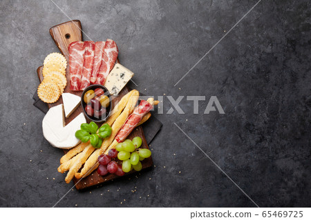 Cheese, meat, grapes and olives antipasto Cheese, meat, grapes and olives antipasto 65469725