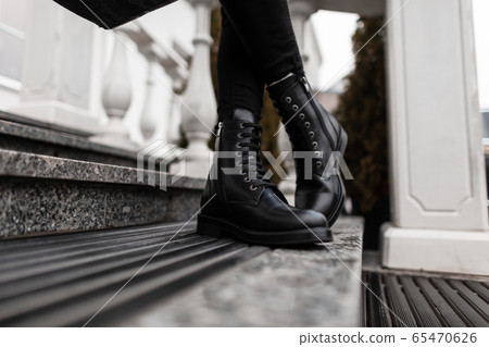 Stylish woman stands in a street in a shoes. Stylish woman stands in a street in a shoes. 65470626