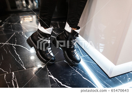 Young trendy woman in black stylish jeans 65470643