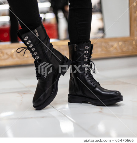 Trendy young woman stands on a tile in store Trendy young woman stands on a tile in store 65470666