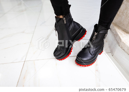 Close up of female legs in black trendy jeans 65470679
