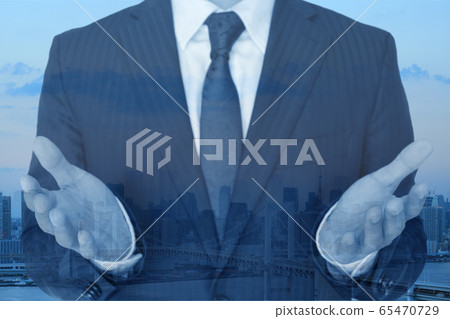 Businessman opening hands city 65470729