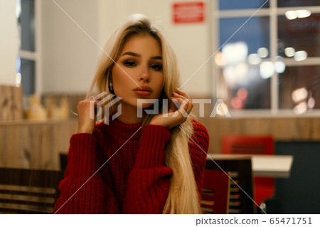 Beautiful young fashionable woman in a red sweater Beautiful young fashionable woman in a red sweater 65471751