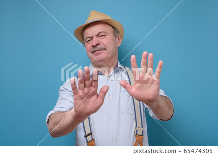 Attractive mature man in summer hat showing Attractive mature man in summer hat showing 65474305