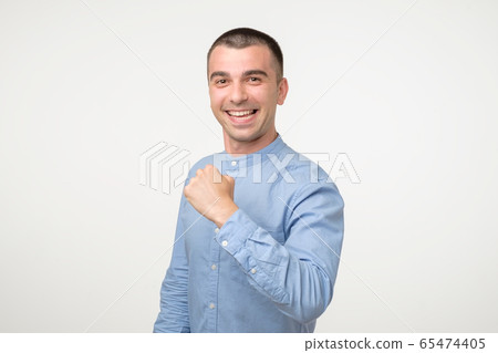 Happy successful young hispanic student showing 65474405