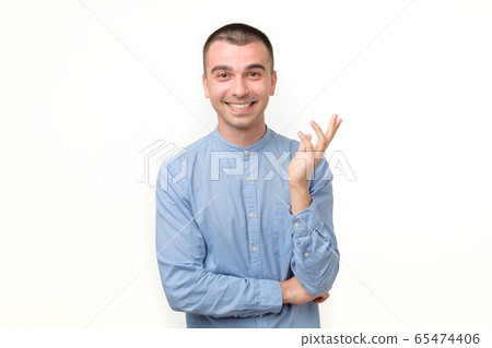 Happy smiling hispanic guy looking at camera 65474406