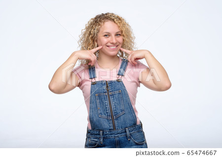 Fresh woman with blonde curly shows us her happy 65474667
