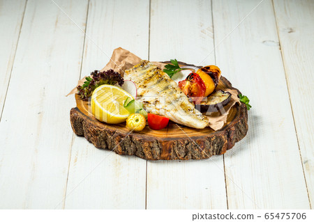 Appetizing delicious grilled fish with vegetables Appetizing delicious grilled fish with vegetables 65475706