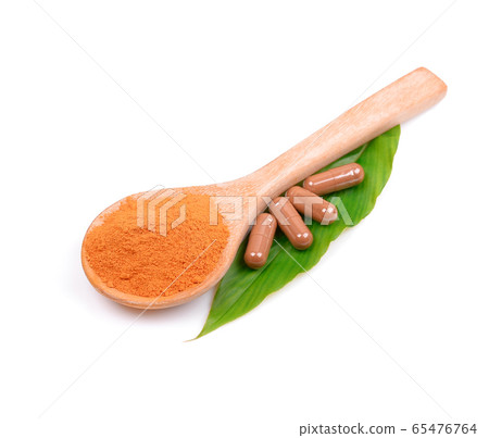 turmeric powder in spoon wood; capsule of turmeric medicine;leave on white background. turmeric powder in spoon wood; capsule of turmeric medicine;leave on white background. 65476764