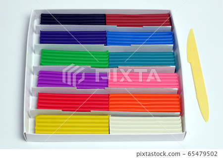 Multi-colored plasticine sticks in a cardboard box Multi-colored plasticine sticks in a cardboard box 65479502