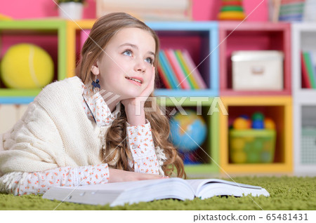 Portrait of cute happy girl studying at home Portrait of cute happy girl studying at home 65481431