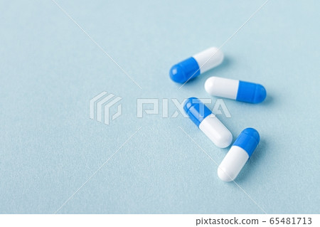 Blue and white capsule tablets 65481713