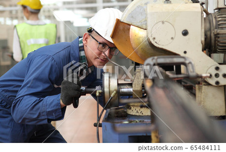 Factory Engineer Operating Hydraulic Tube Bender Factory Engineer Operating Hydraulic Tube Bender 65484111