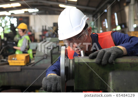 Factory Engineer operating big machine cut off 65484129