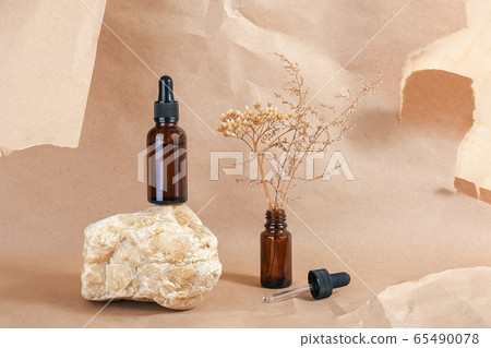 Serum or essential oil in brown glass bottle with Serum or essential oil in brown glass bottle with 65490078