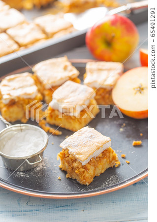 Five cubes of apple plie with a cream topping Five cubes of apple plie with a cream topping 65491291