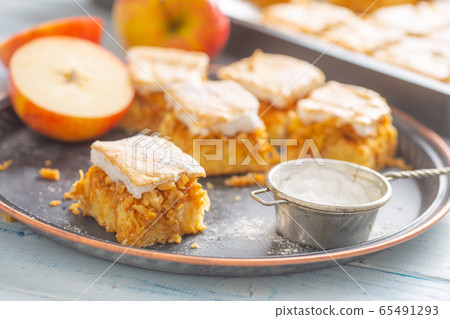 Five cubes of apple plie with a cream topping 65491293