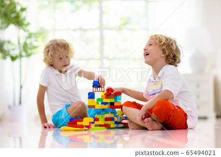 Child playing with toy blocks. Kids play. 65494021