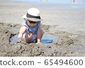 Children playing sand at sea 65494600