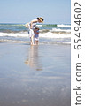 Parent and child playing in the sea 65494602