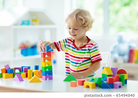 Kids toys. Child building tower of toy blocks. Kids toys. Child building tower of toy blocks. 65494840