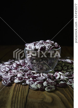 raw haricot in a glass bowl on a wooden table, biology organic protein 65495077