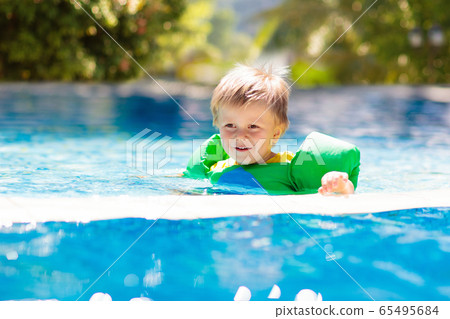 Kids in swimming pool. Life jacket for child. Kids in swimming pool. Life jacket for child. 65495684