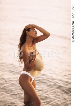 Tanned Woman Resting in Water During Summer Vacations Tanned Woman Resting in Water During Summer Vacations 65500543