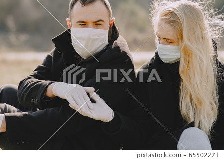 People in a masks walks in a spring forest People in a masks walks in a spring forest 65502271