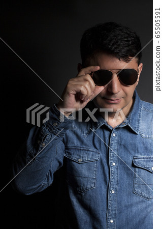 Portrait of man in Blue jean shirt with sunglasses Portrait of man in Blue jean shirt with sunglasses 65505591