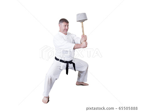 Adult athlete performs formal goju-ryu exercises. 65505888