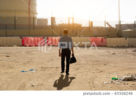 A man walks through an abandoned area of the city. A man walks through an abandoned area of the city. 65508246