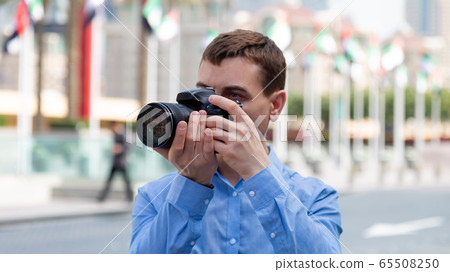 Photographer tourist on the streets of Dubai. Photographer tourist on the streets of Dubai. 65508250