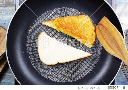 Chef baking parmesan cheese toast by pan Chef baking parmesan cheese toast by pan 65508446