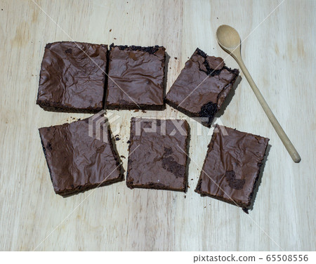 Pieces of fresh brownie on wooden background. Pieces of fresh brownie on wooden background. 65508556