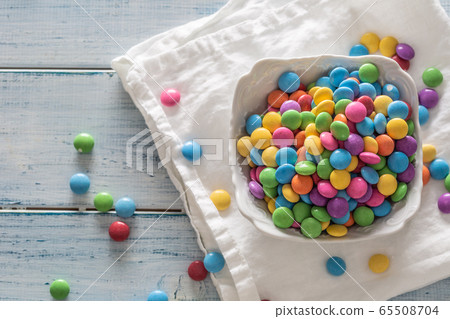 Top view of a bowl full of colorful sweets on a 65508704