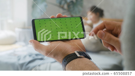 Man holding a smartphone 65508857