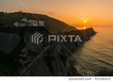 Sunset at San Telmo Church and cliffs in Zumaia 65508920