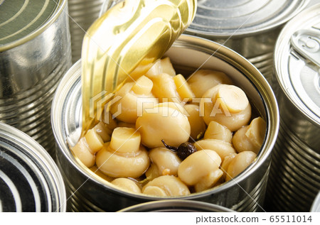 Canned button mushrooms in just opened tin can. 65511014