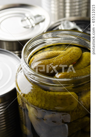 Canned pickles in just opened glass mason jar. Canned pickles in just opened glass mason jar. 65511015