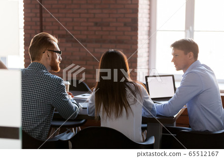 Rear view at business team people talking at office meeting Rear view at business team people talking at office meeting 65512167