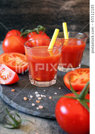 Two glasses of tomato juice, bunch of tomatoes Two glasses of tomato juice, bunch of tomatoes 65512185
