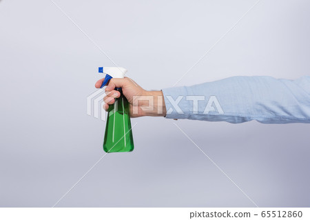 Male hand holding spray gun on white background. Male hand holding spray gun on white background. 65512860