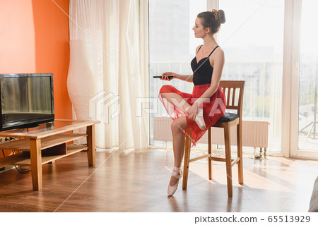 Beautiful ballerina with tv remote at home Beautiful ballerina with tv remote at home 65513929