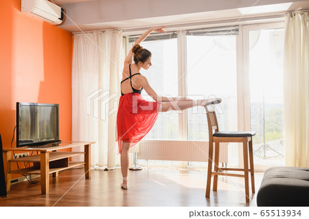 Ballet dancer stretching at home at quarantine Ballet dancer stretching at home at quarantine 65513934