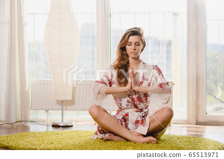 Relaxed young woman do yoga at home Relaxed young woman do yoga at home 65513971