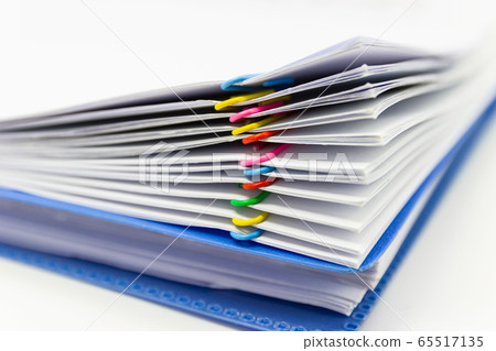 close up of Stack of papers files piles of unfinished documents achieves with paper clips  65517135