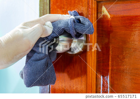 Prevention cleaning Door handles by Disinfectant solution for killing corona virus on touching surfaces, concept coronavirus COVID19. 65517171