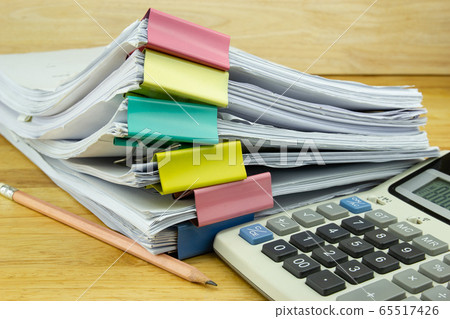 file folder and Stack of business report paper file with ..Calculator on the table in a work office, concept document in work office 65517426