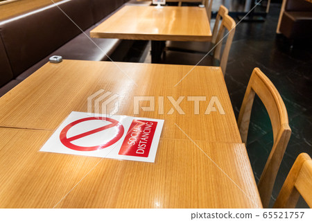 New normal with table signage prohibit occupancy to maintain social distance 65521757